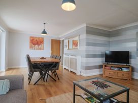 A dining room with a table and chairs at Rainbow View in Churchstanton near Churchinford