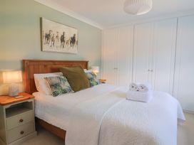A bedroom with a bed and nightstand at Rainbow View Churchstanton near Churchinford