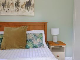 A bedroom with a bed and nightstand at Rainbow View Churchstanton near Churchinford