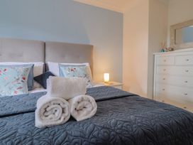 A bedroom with a bed and towels arranged at Rainbow View in Churchstanton near Churchinford