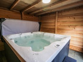 A hot tub in a wooden interior at The Lloyd George in Bontnewydd, Gwynedd