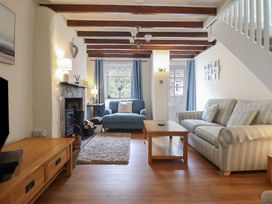A living room with a sofa and a coffee table at Riverside Cottage Beddgelert
