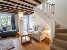 A living room with a sofa and coffee table at Riverside Cottage in Beddgelert