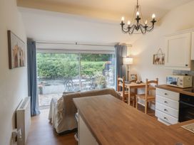 A kitchen with a table and chairs at Riverside Cottage in Beddgelert