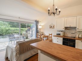 A kitchen with a sofa and table at Riverside Cottage in Beddgelert