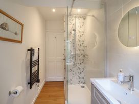 A bathroom with a shower and wash basin at Riverside Cottage in Beddgelert