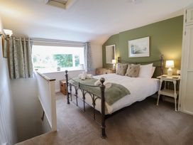 A bedroom with a bed and a window at Riverside Cottage in Beddgelert