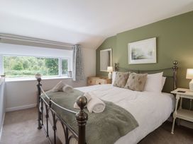 A bedroom with a bed and window at Riverside Cottage in Beddgelert