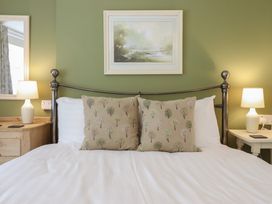 A bedroom with a bed and lamps at Riverside Cottage Beddgelert