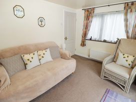 A living room with a sofa and armchair at Penn Lea in Penally