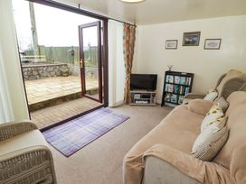 A living room with a sofa and television at Penn Lea in Penally