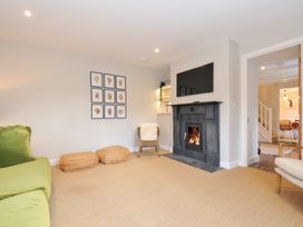 A living room with a fireplace and sofa at Mermaid Cottage in Port Isaac