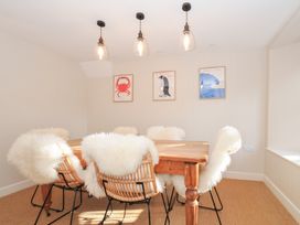 A dining room with a wooden table and chairs at Mermaid Cottage in Port Isaac
