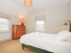 A bedroom with a bed and chest of drawers at Mermaid Cottage in Port Isaac
