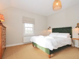 A bedroom with a bed and lamp at Mermaid Cottage in Port Isaac