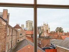 View of rooftops and York Minster cathedral through a window at 6 Granary Court in York