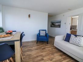 A living room with a dining table and chairs at Sunset Sea View Chalet in Millbrook
