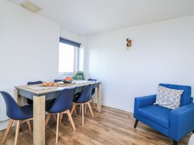 A dining room with a table and chairs at Sunset Sea View Chalet in Millbrook