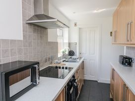 A kitchen with cabinets and appliances at Sunset Sea View Chalet in Millbrook
