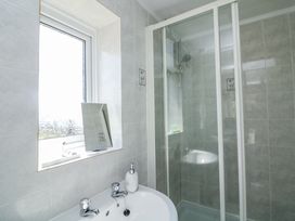 A bathroom with a sink and shower at Sunset Sea View Chalet in Millbrook
