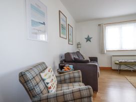 A living room with chairs and a sofa at Flat 4 in Newquay