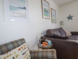 A living room with sofa and coffee table at Flat 4 in Newquay