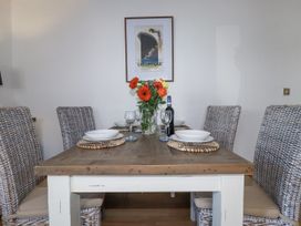 A dining room with a table set for four at Flat 4 in Newquay