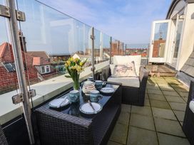 A balcony with a table and chairs at Sunset View in Whitby