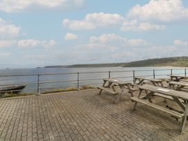 An outdoor seating area near the ocean at Harbour Studio in Sennen Cove