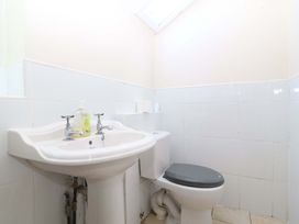 A bathroom with a sink and toilet at Cwm Eilir in Criccieth