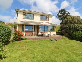 A house with a garden and outdoor seating at Cwm Eilir in Criccieth