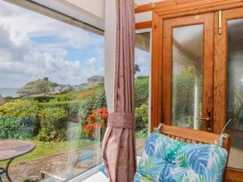 A conservatory with a view of the garden and hills at Cwm Eilir Criccieth