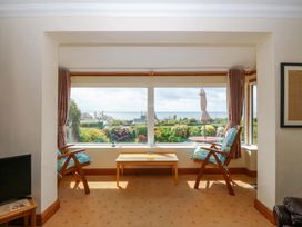 A living room with chairs and a table at Cwm Eilir in Criccieth