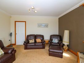 A living room with brown furniture at Cwm Eilir in Criccieth