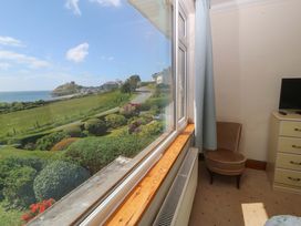 A bedroom with a view of the landscape at Cwm Eilir in Criccieth