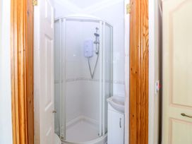 A bathroom with a shower and sink at Cwm Eilir Criccieth