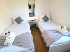 A bedroom with two single beds and a side table at Lodge 1 in South Hykeham