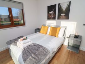 A bedroom with a bed and window at Lodge 1 South Hykeham