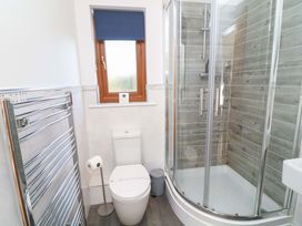 A bathroom with a shower and toilet at Lodge 1 South Hykeham
