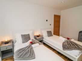 A bedroom with two beds and bedside tables at Lodge 24 in South Hykeham