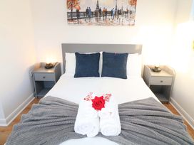 A bedroom featuring a bed with towels and pillows at Lodge 2 South Hykeham