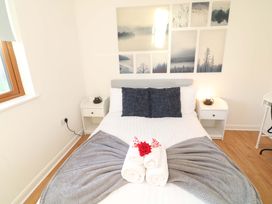 A bedroom with a bed and wall art at Lodge 2 South Hykeham