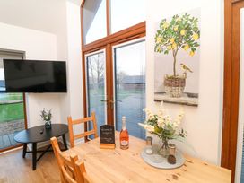 A dining room with a table and television at Lodge 3 Thorpe-On-The-Hill