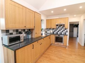 A kitchen with cabinets and appliances at Lodge 3 Thorpe-On-The-Hill