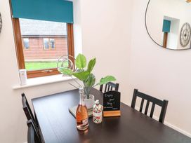 A dining room with a table and chairs at Lodge 4 in South Hykeham