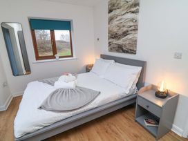 A bedroom with a bed and window at Lodge 4 South Hykeham
