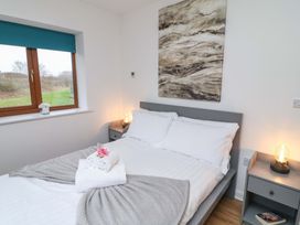 A bedroom with a bed and side table at Lodge 4 in South Hykeham