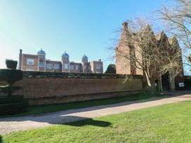An outdoor view of a historical building and surrounding gardens at Lodge 4 South Hykeham