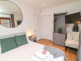 A bedroom with a bed, TV, and wardrobe at Lodge 7 in South Hykeham