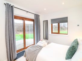 A bedroom with a bed and windows at Lodge 7 South Hykeham